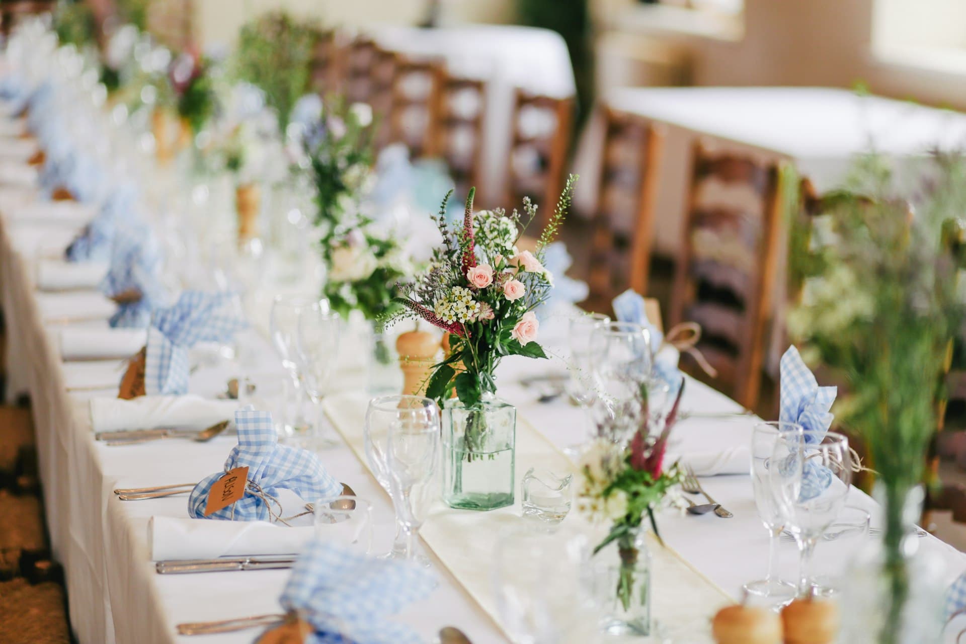 Wedding table setting with white linen and floral centrepieces